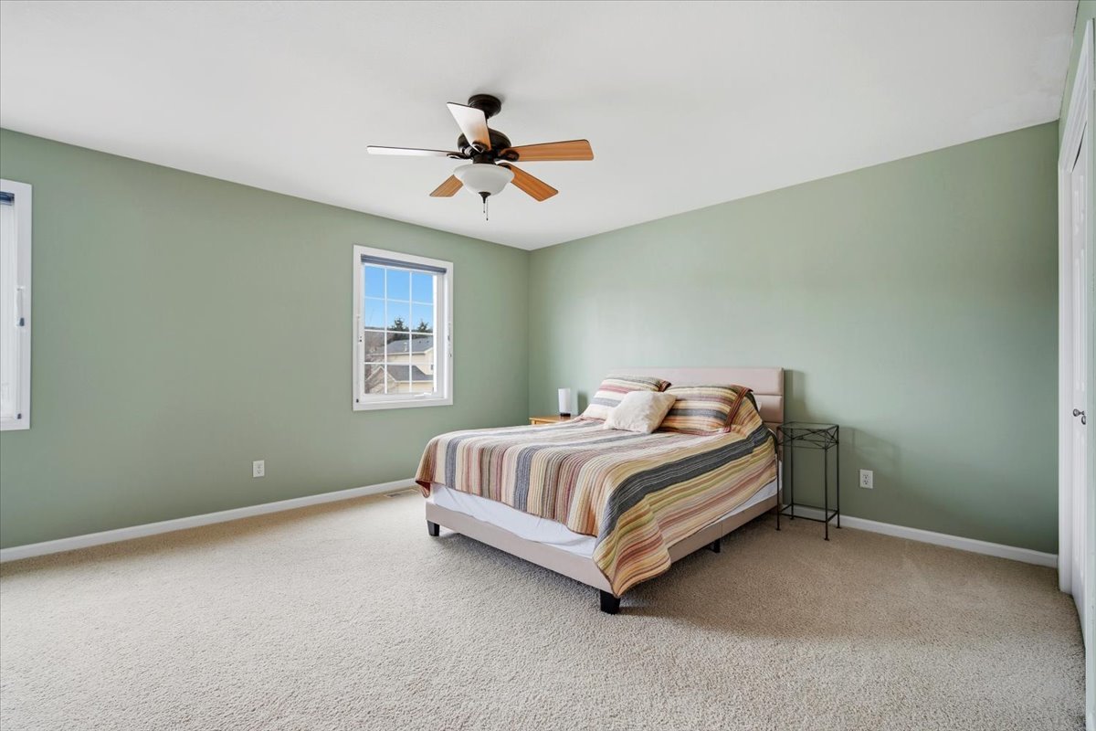 2429 Grey Fox Trail Bloomington, IL 61705 - Photo 21 of 43 a spacious bedroom with a bed and a ceiling fan