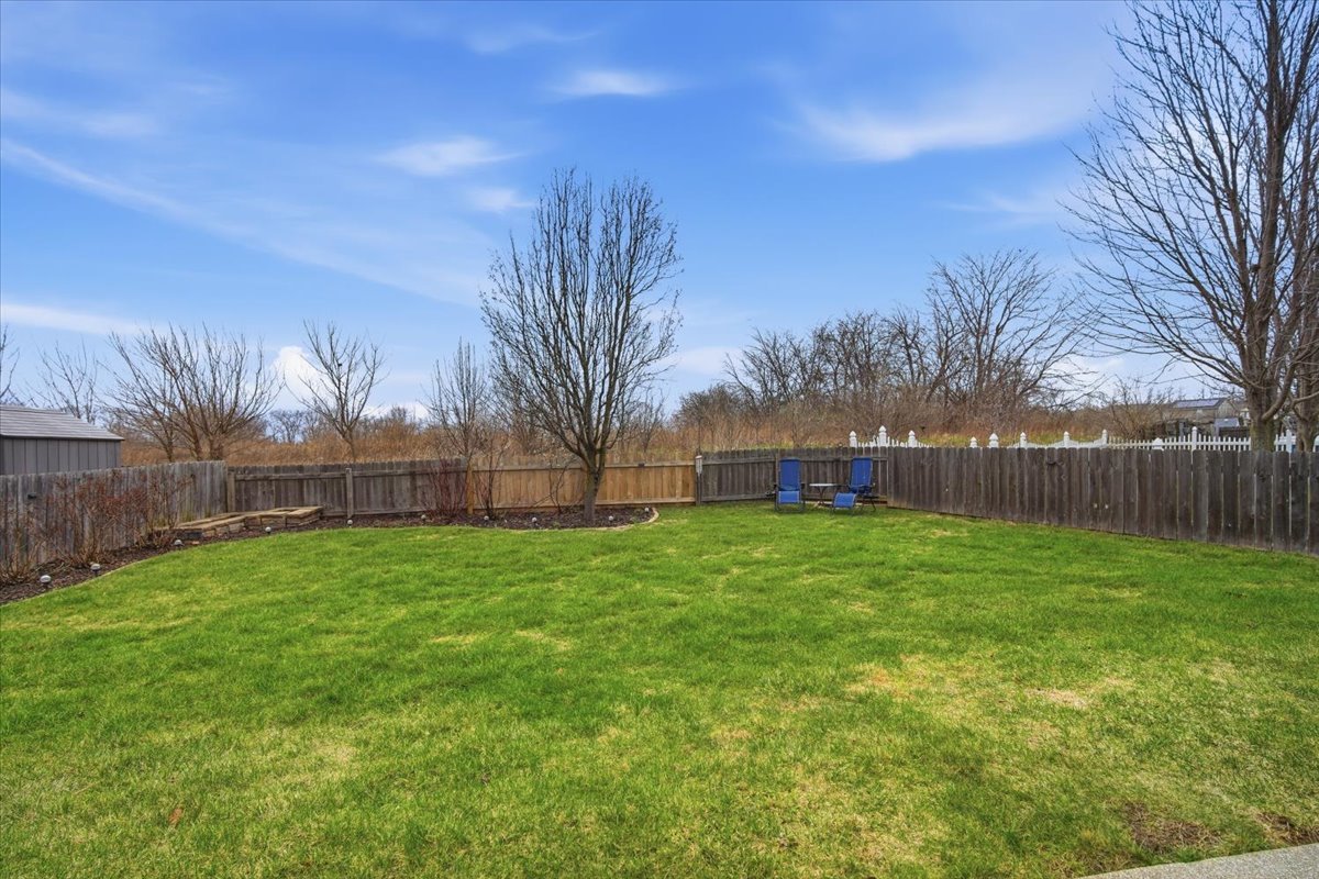 2429 Grey Fox Trail Bloomington, IL 61705 - Photo 32 of 43 a small garden in front of a house