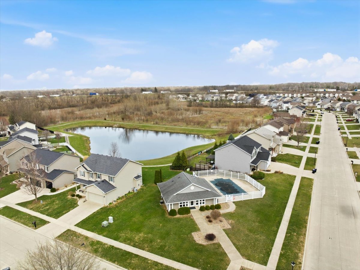 2429 Grey Fox Trail Bloomington, IL 61705 - Photo 38 of 43 a view of a lake with couches in the patio