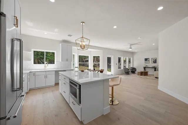 a kitchen with a sink stove and cabinets