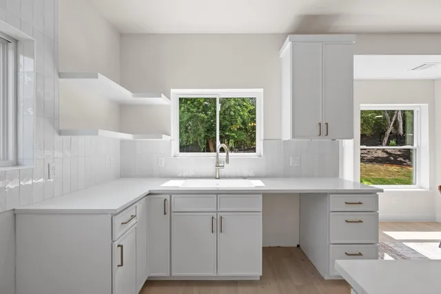 a kitchen with a sink and a window