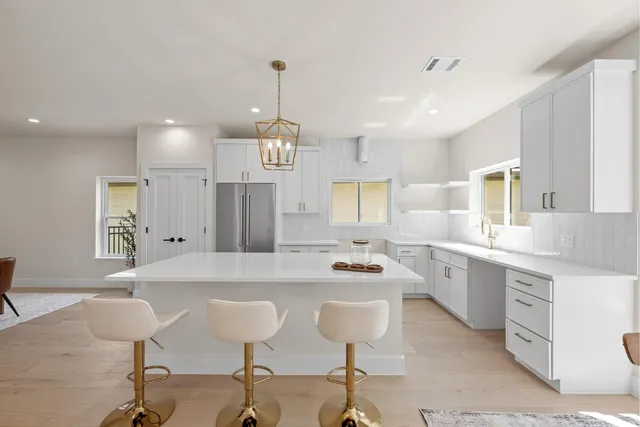 a large kitchen with a table and chairs