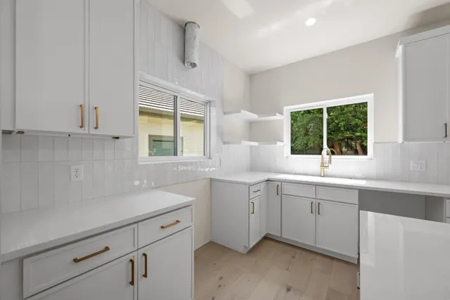 a bedroom with a large bed and a potted plant