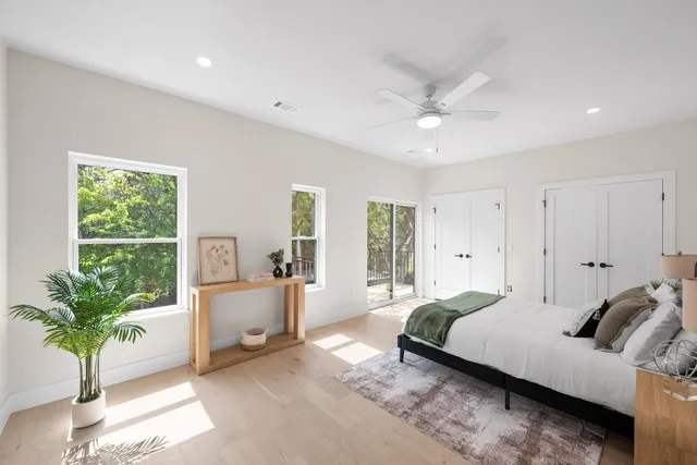 a bedroom with a large bed and a large window