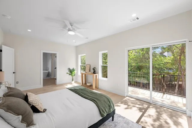 a bathroom with a tub a sink and mirror