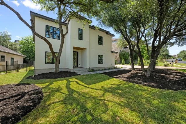 a front view of house with yard and green space