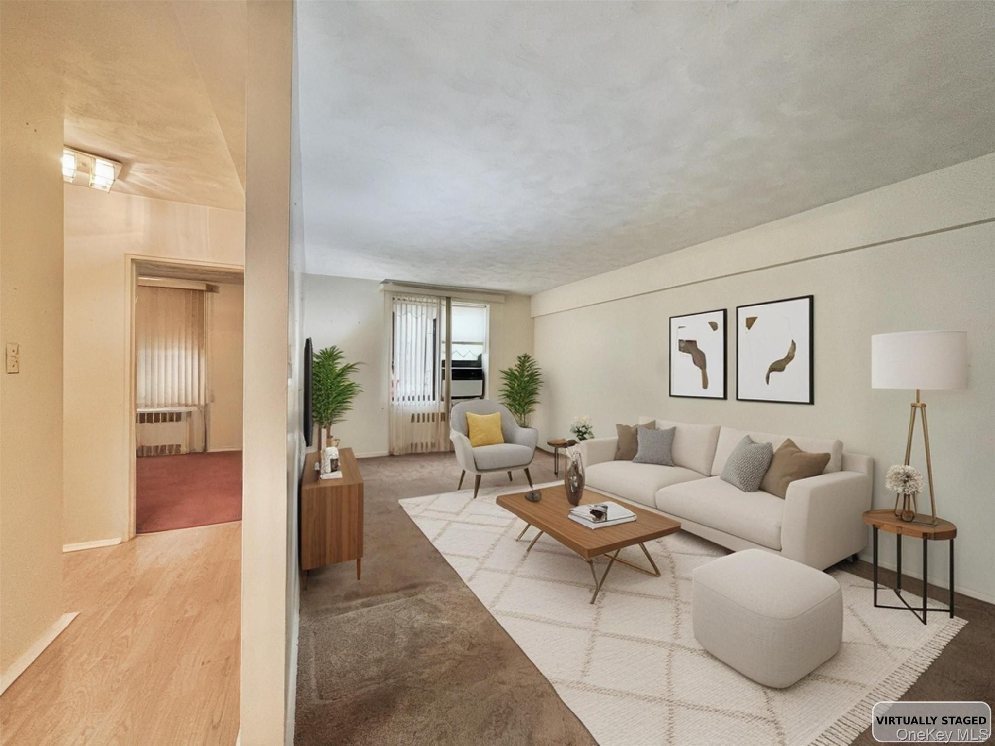 140-14 28th Road, Unit 1A Queens, NY 11354 - Photo 2 of 8 a living room with furniture and a table