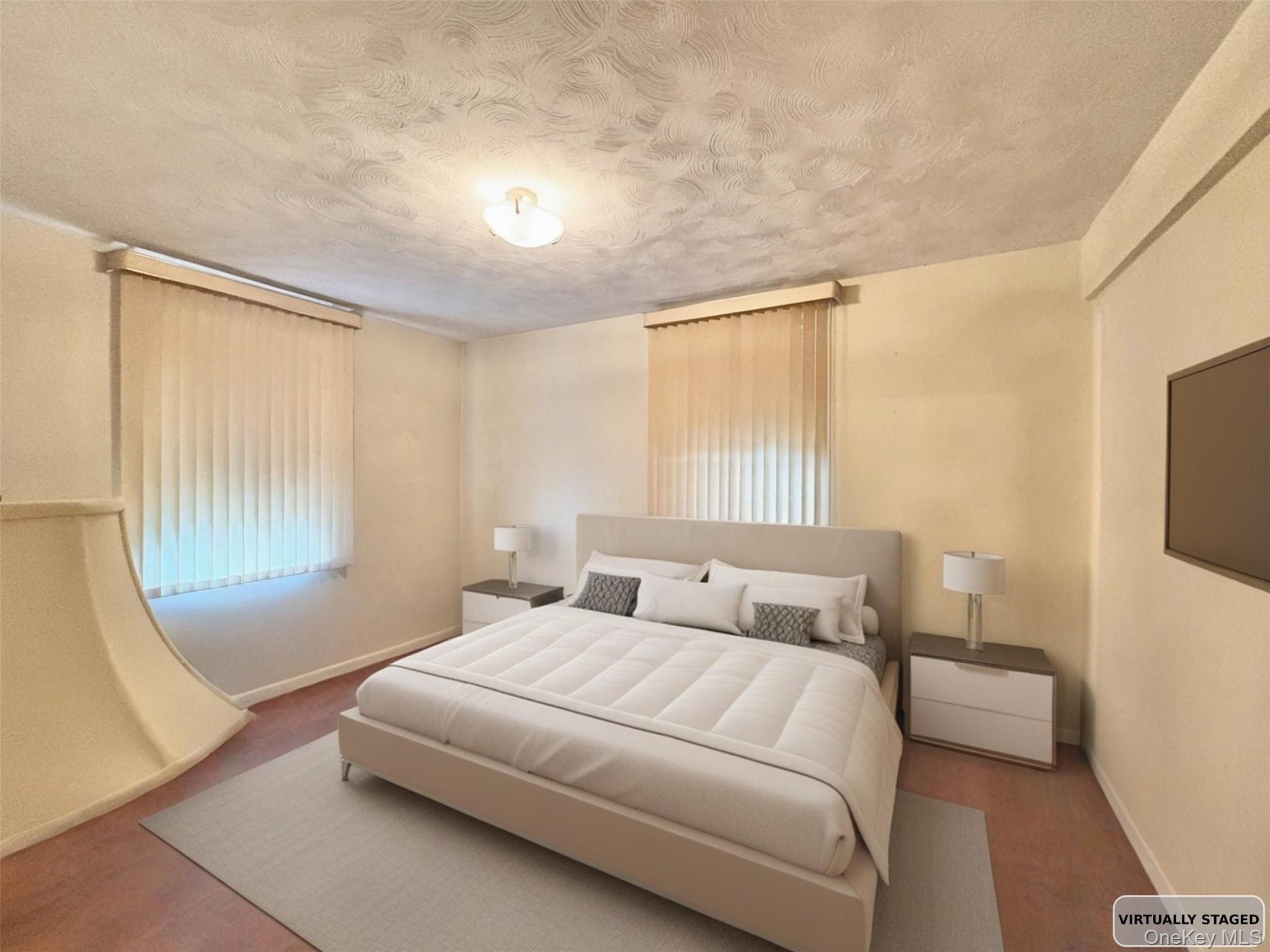 140-14 28th Road, Unit 1A Queens, NY 11354 - Photo 4 of 8 a bedroom with a bed a mirror and a window