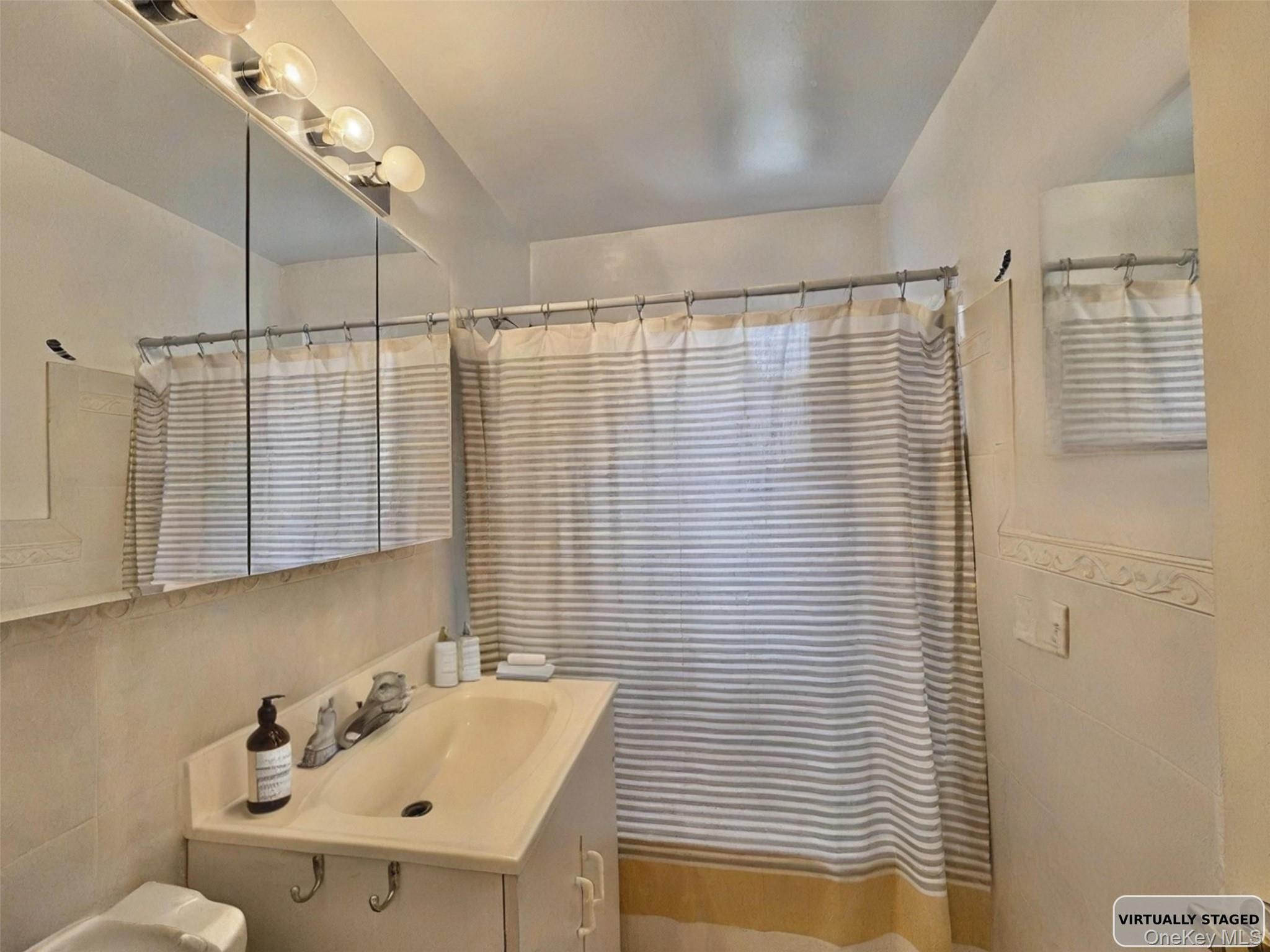 140-14 28th Road, Unit 1A Queens, NY 11354 - Photo 6 of 8 a bathroom with a sink and a shower
