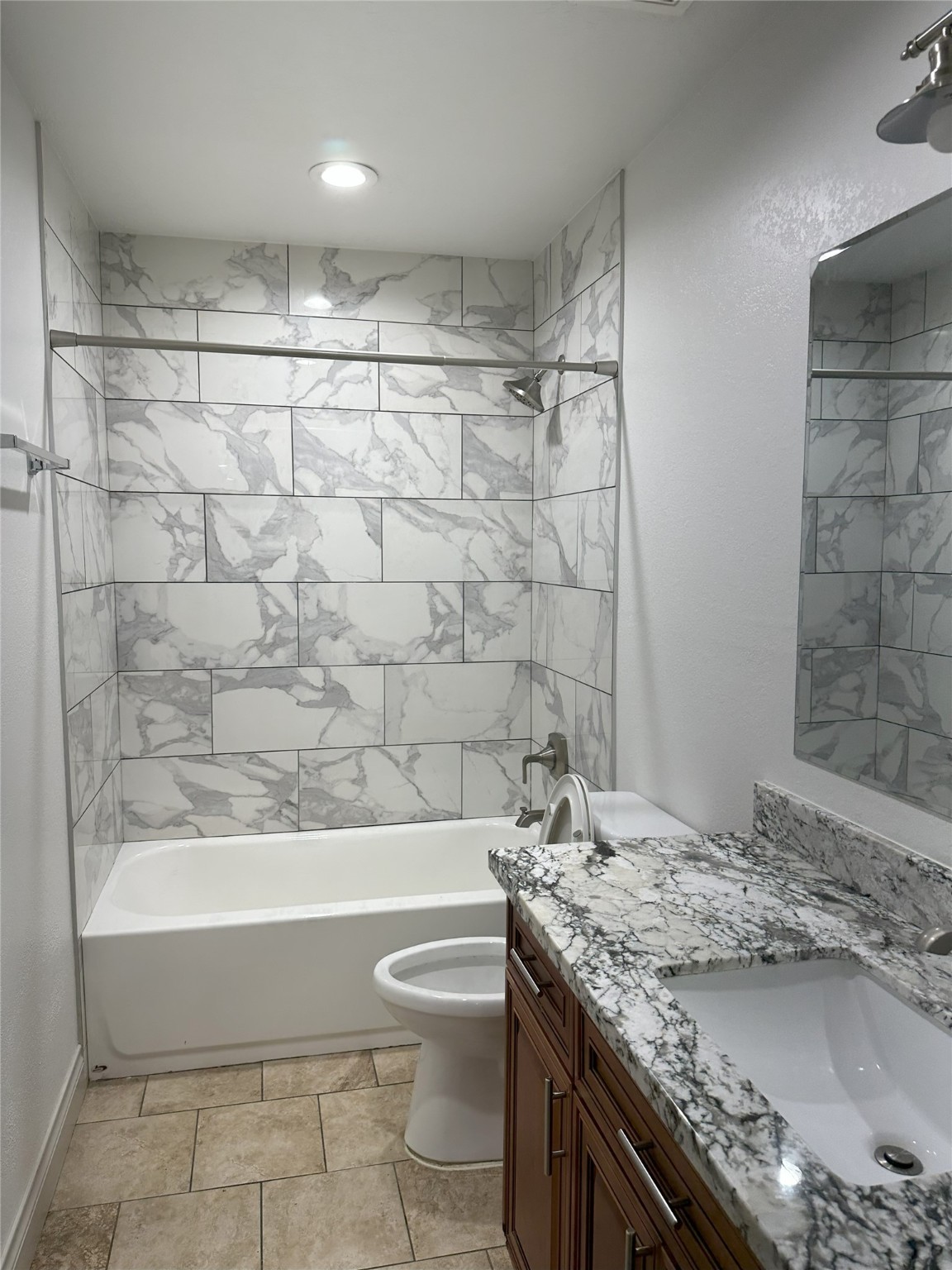 6646 Limestone Street Houston, TX 77092 - Photo 12 of 23 a bathroom with a granite countertop sink a toilet and bathtub