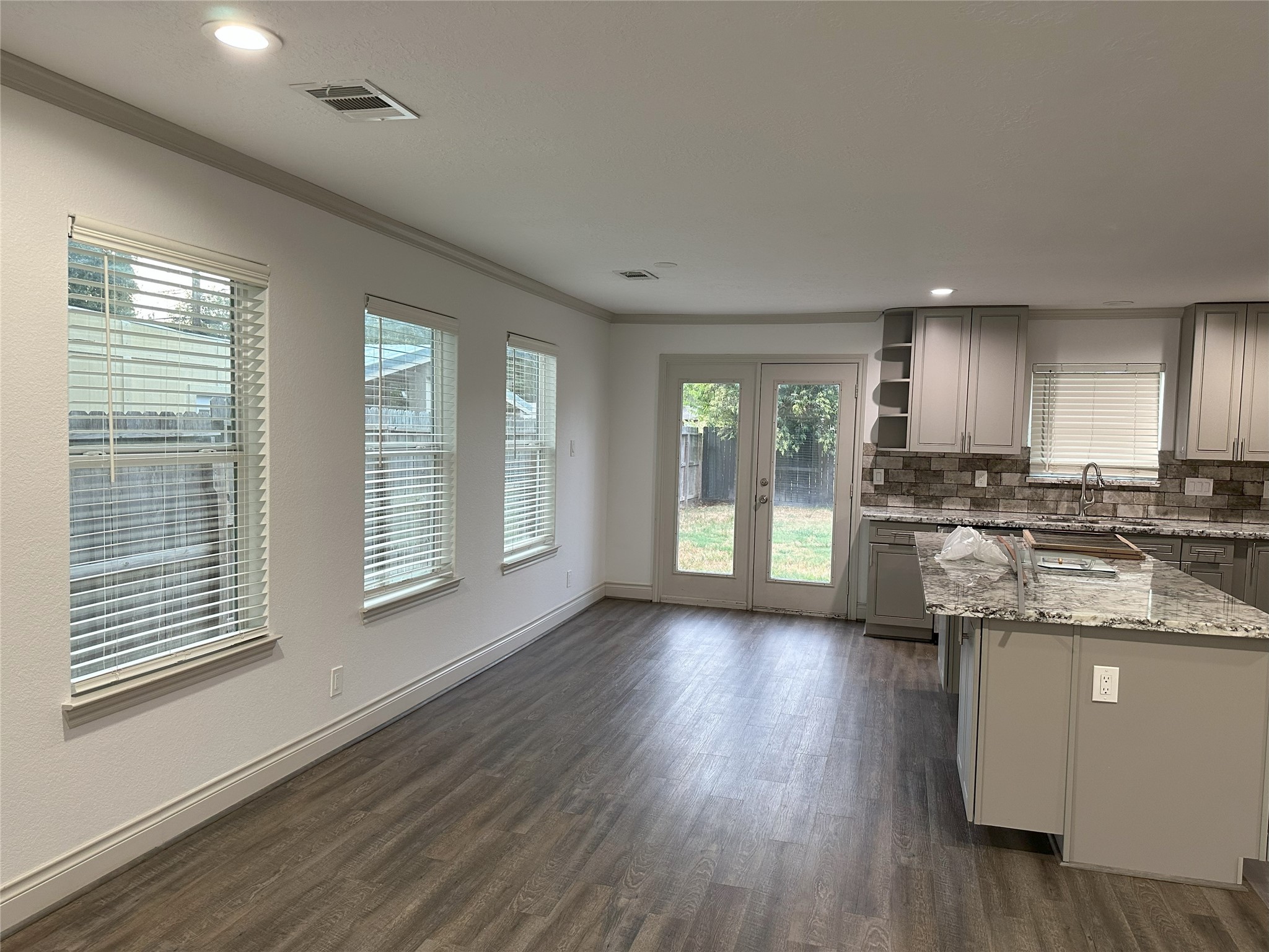 6646 Limestone Street Houston, TX 77092 - Photo 4 of 23 a kitchen with stainless steel appliances granite countertop a stove a sink and a large window