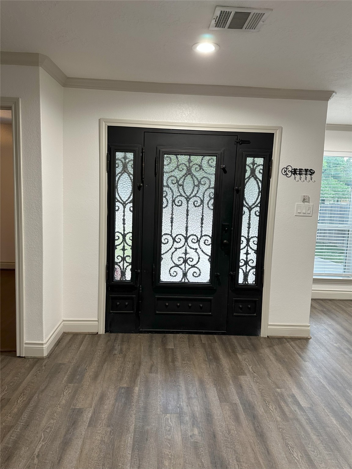 6646 Limestone Street Houston, TX 77092 - Photo 6 of 23 an empty room with wooden floor and windows