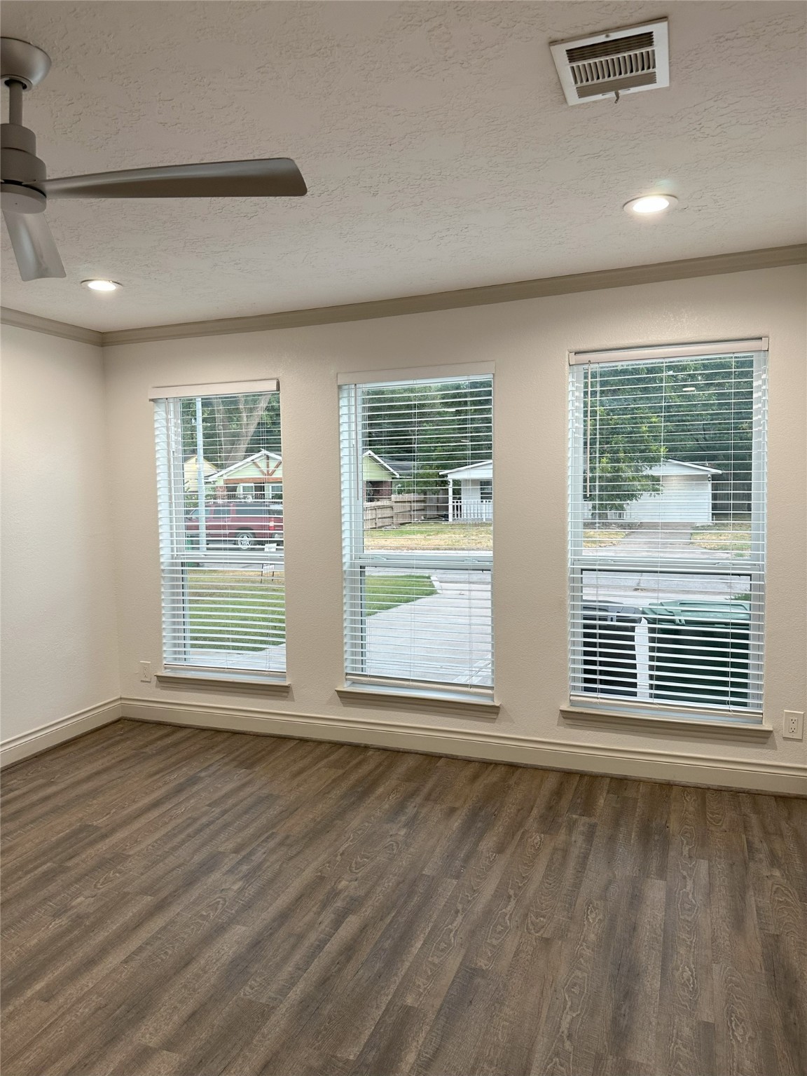 6646 Limestone Street Houston, TX 77092 - Photo 7 of 23 a view of an empty room with wooden floor and a window