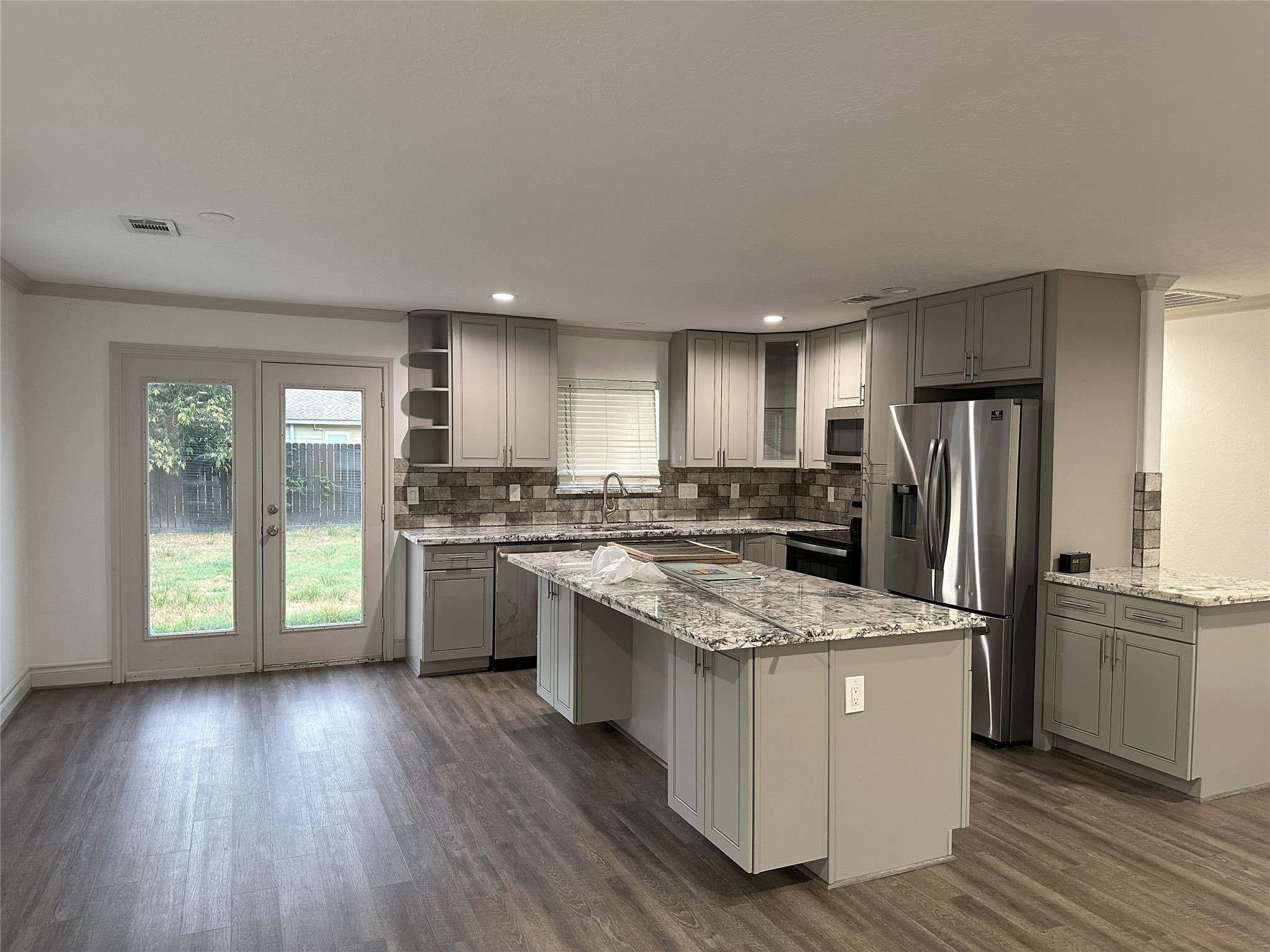 6646 Limestone Street Houston, TX 77092 - Photo 8 of 23 a kitchen with a refrigerator a sink dishwasher stove and oven with wooden floor