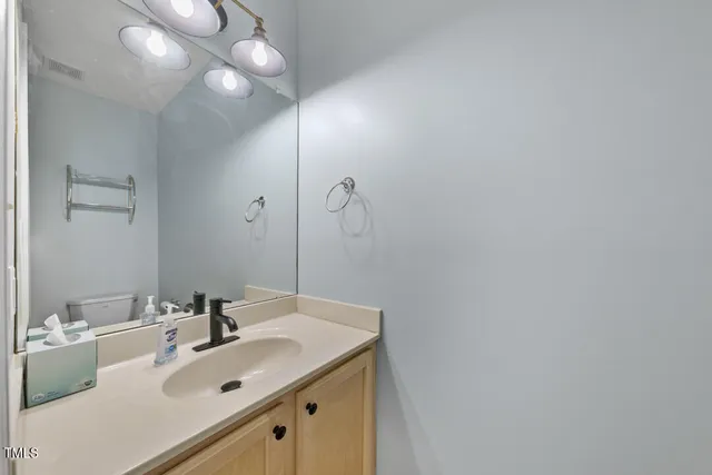 a bathroom with a sink vanity and a mirror