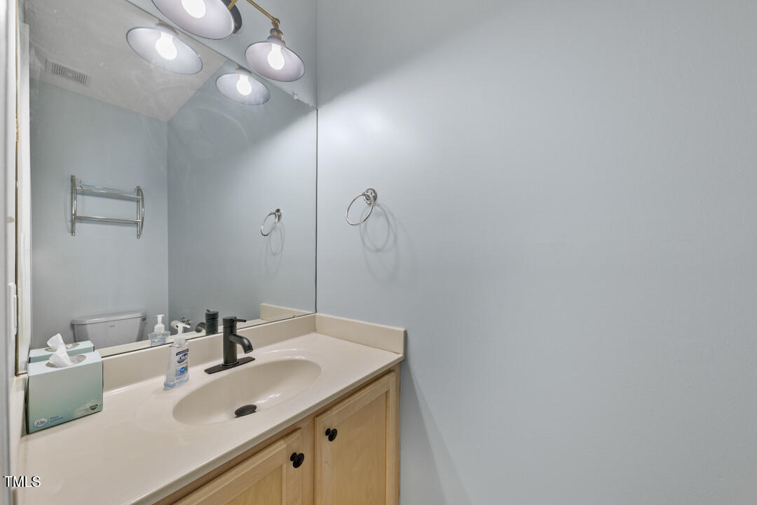 203 Bluefield Road Chapel Hill, NC 27517 - Photo 15 of 34 a bathroom with a sink vanity and a mirror