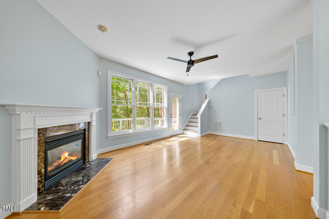 203 Bluefield Road Chapel Hill, NC 27517 - Photo 18 of 34 a view of empty room with wooden floor and fireplace
