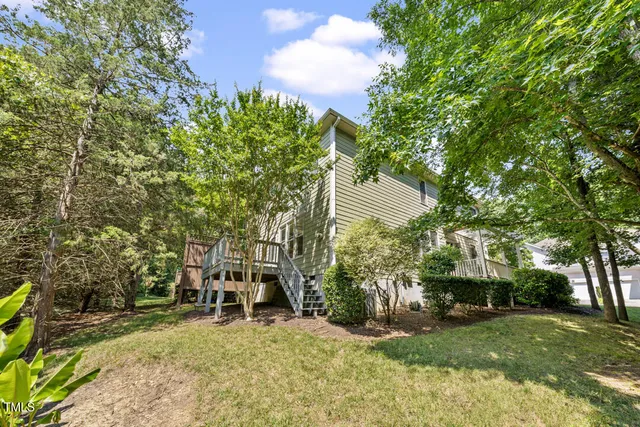 a backyard of a house with table and chairs