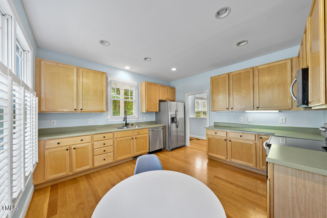 203 Bluefield Road Chapel Hill, NC 27517 - Photo 10 of 34 a large kitchen with stainless steel appliances granite countertop a sink and a stove