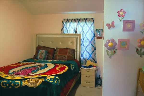 a bedroom with a bed and ceiling fan