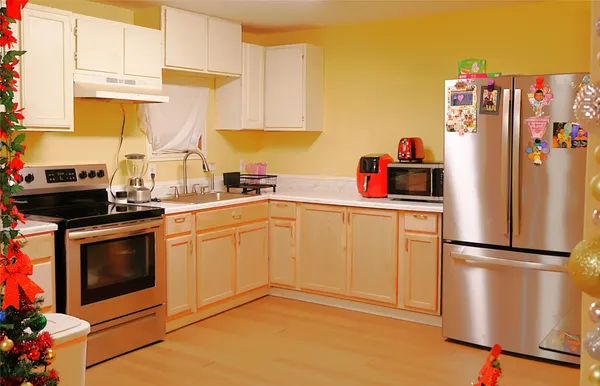 a kitchen with a refrigerator sink and cabinets