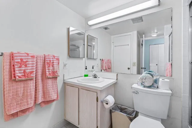 a bathroom with a sink toilet vanity and tub