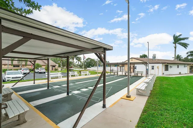 a view of a balcony with floor to ceiling windows and wooden floor