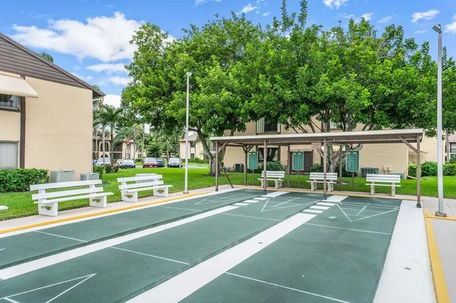 a view of house with swimming pool and yard