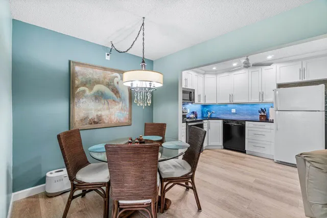 a view of a dining room with furniture wooden floor and chandelier