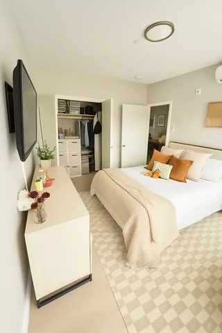 a bedroom with bed and flat screen tv
