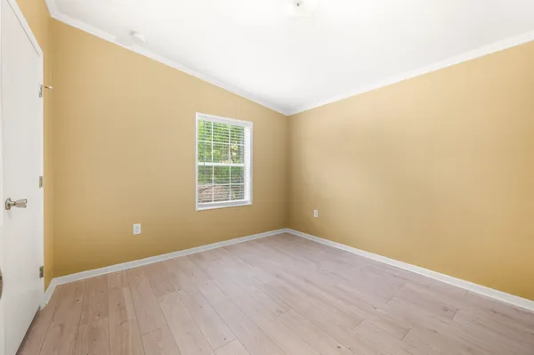 an empty room with windows and closet