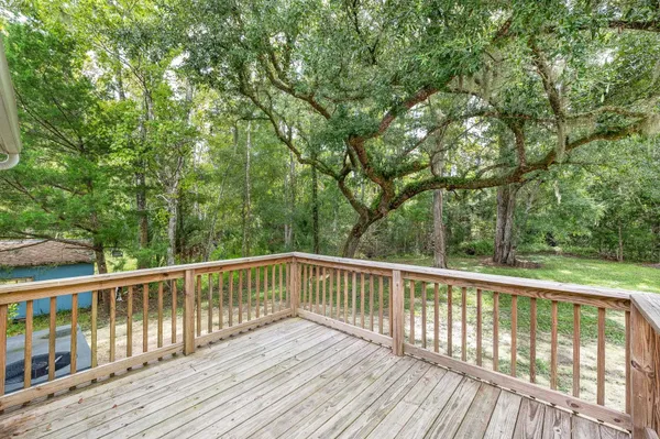 a view of balcony with wooden floor and fence