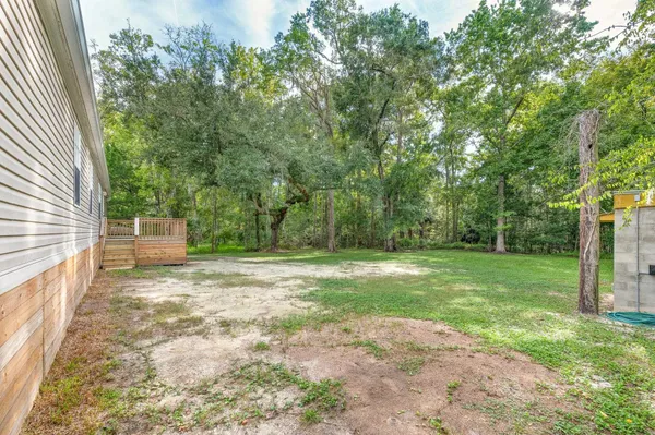 a view of a yard with large trees