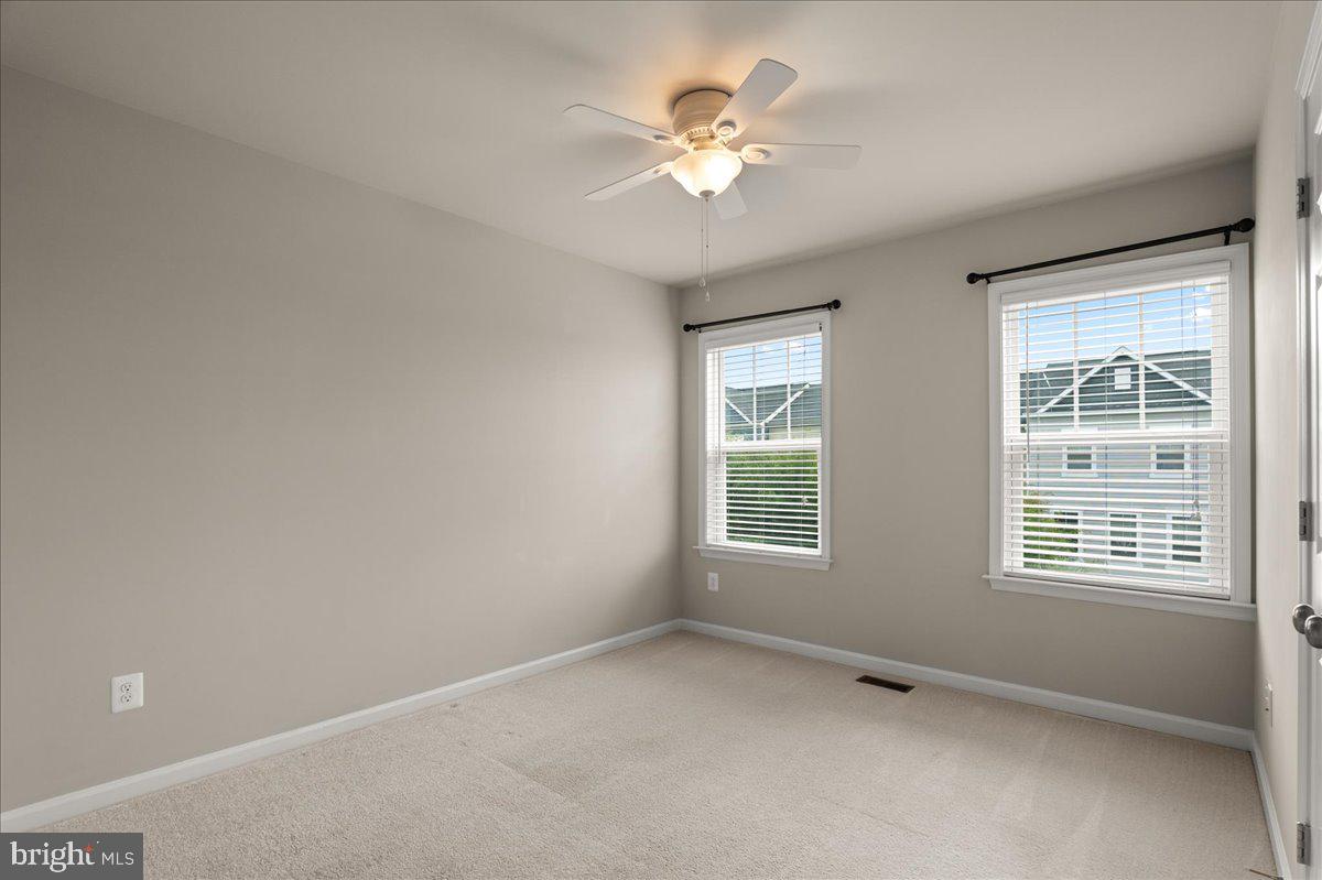 101 Jitterbug Way Stephenson, VA 22656 - Photo 25 of 39 an empty room with chandelier fan and windows