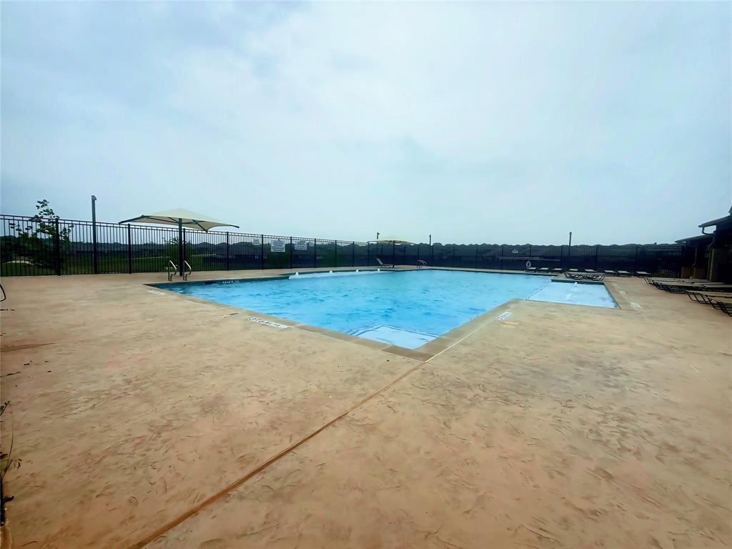 9604 Cherryville Road Fort Worth, TX 76108 - Photo 39 of 40 Expansive community outdoor swimming pool with an integrated shallow water area, surrounded by stamped concrete decking