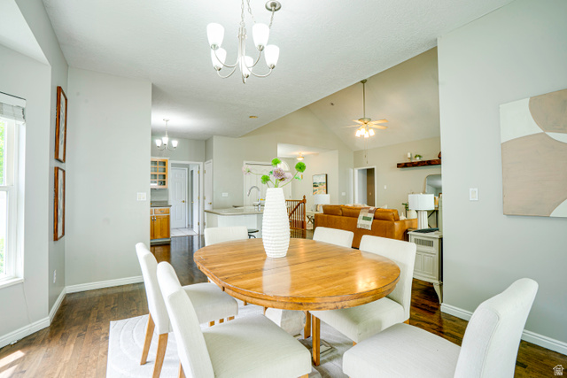 1433 Forge Way Draper, UT 84020 - Photo 6 of 29 Dining area featuring wood-finish flooring, a contemporary chandelier, and light gray wall tones