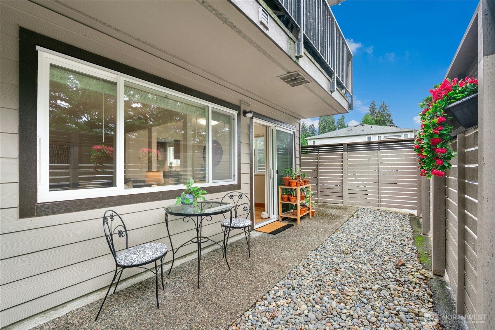 9523 Northeast 180th Street, Unit A102 Bothell, WA 98011 - Photo 23 of 29 a backyard of a house with table and chairs