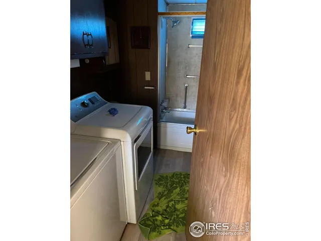 a kitchen with a sink cabinets stainless steel appliances and a window