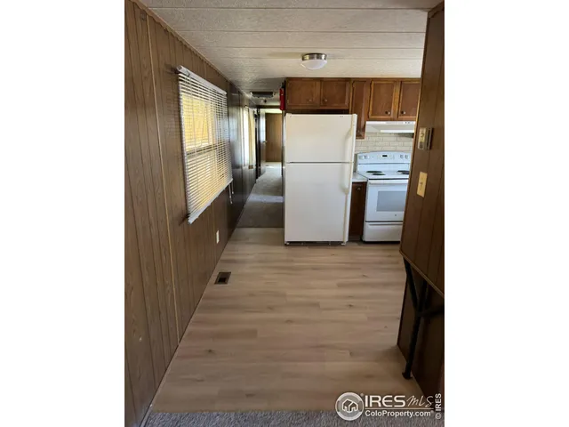 a kitchen with refrigerator and car