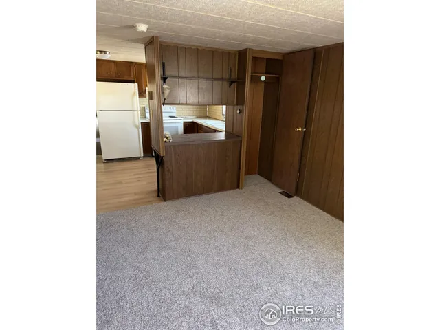a kitchen with a refrigerator and a sink
