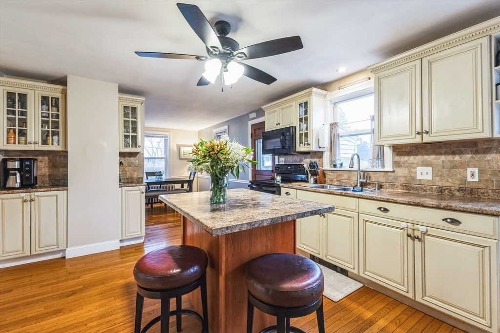 21 Wilson Road Somerset, MA 02726 - Photo 3 of 37 a kitchen with granite countertop white cabinets and chairs