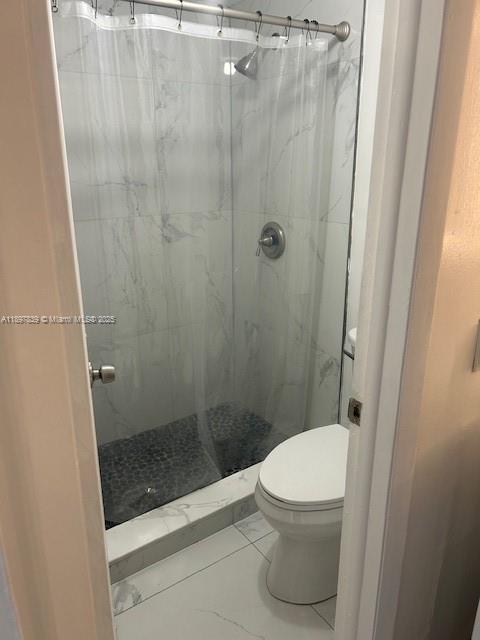 10661 Southwest 108th Avenue, Unit 2E Miami, FL 33176 - Photo 31 of 33 a bathroom with a toilet and a shower
