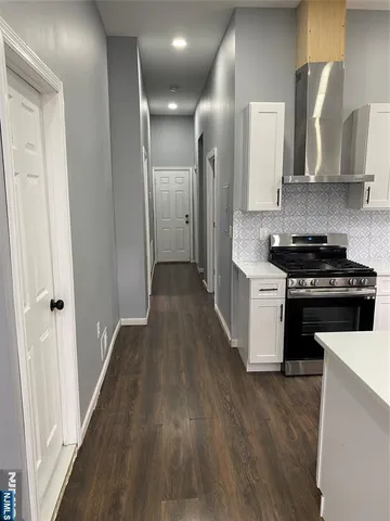 a kitchen with stainless steel appliances a stove top oven and cabinets