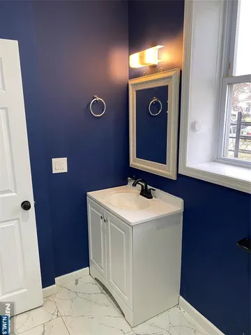 a bathroom with a sink a mirror and vanity