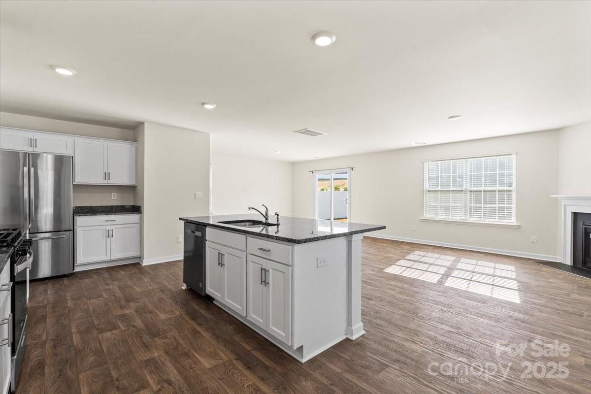 5043 Fandango Road York, SC 29745 - Photo 12 of 34 a kitchen with stainless steel appliances granite countertop a stove and a refrigerator