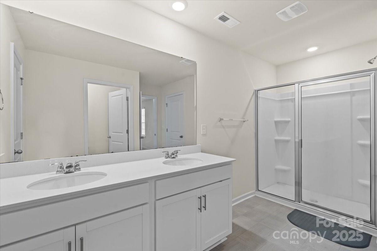 5043 Fandango Road York, SC 29745 - Photo 28 of 34 a bathroom with a double vanity sink mirror and shower