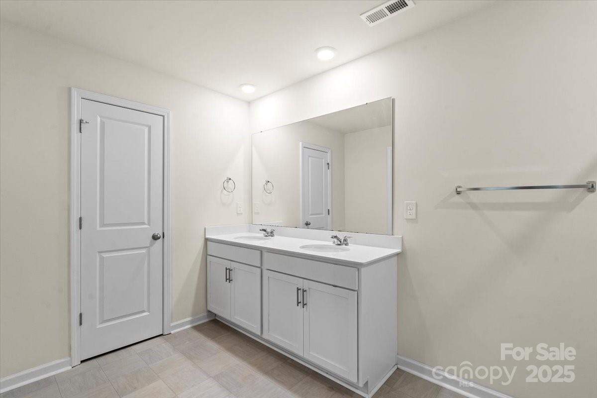 5043 Fandango Road York, SC 29745 - Photo 29 of 34 a spacious bathroom with a double vanity sink a mirror and a shower