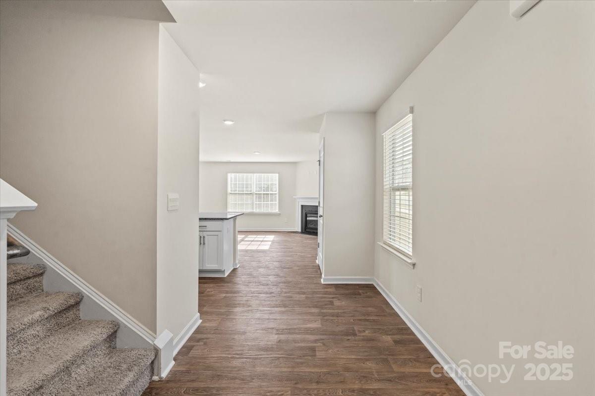 5043 Fandango Road York, SC 29745 - Photo 4 of 34 a view of a hallway with wooden floor and a bathroom
