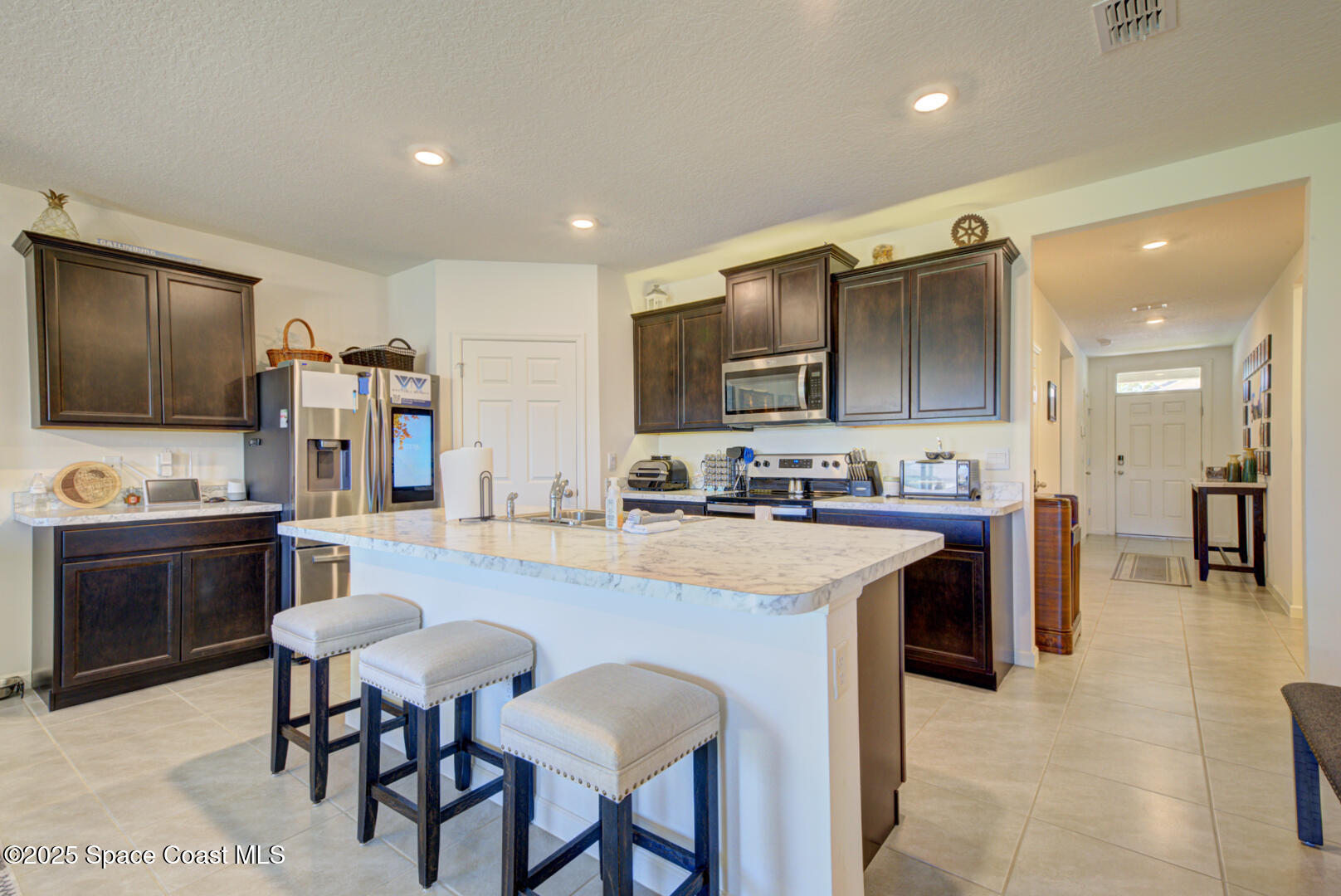 4941 Talbot Boulevard Cocoa, FL 32926 - Photo 15 of 48 a large kitchen with cabinets chairs and a stove