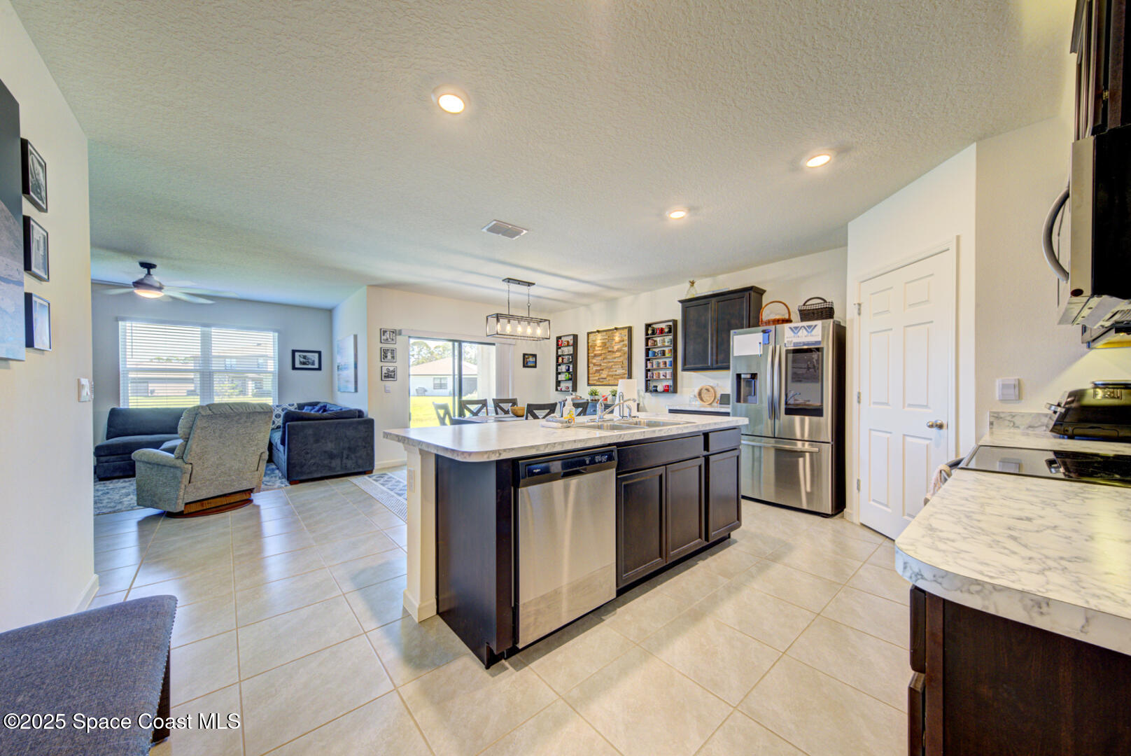 4941 Talbot Boulevard Cocoa, FL 32926 - Photo 16 of 48 a large kitchen with a large counter top cabinets and stainless steel appliances